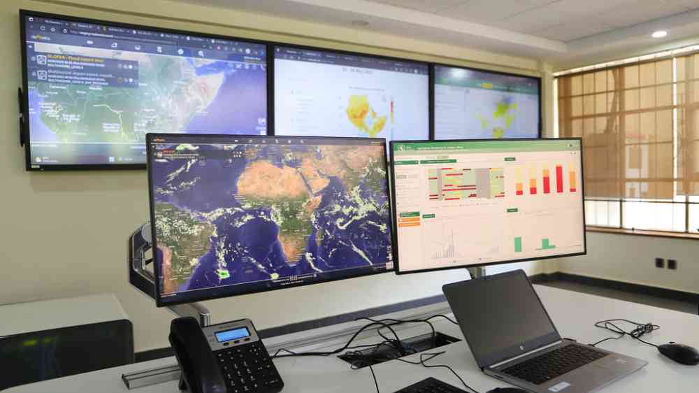 Computer screens showing maps and data