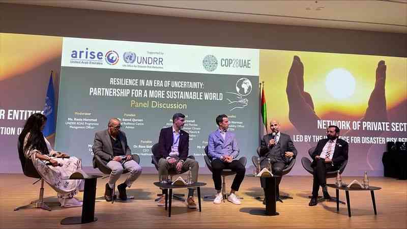 People sitting and talking at a panel discussion in COP28